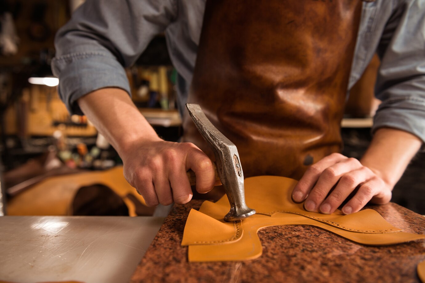 Skilled artisan handcrafting a leather wallet in a traditional workshop